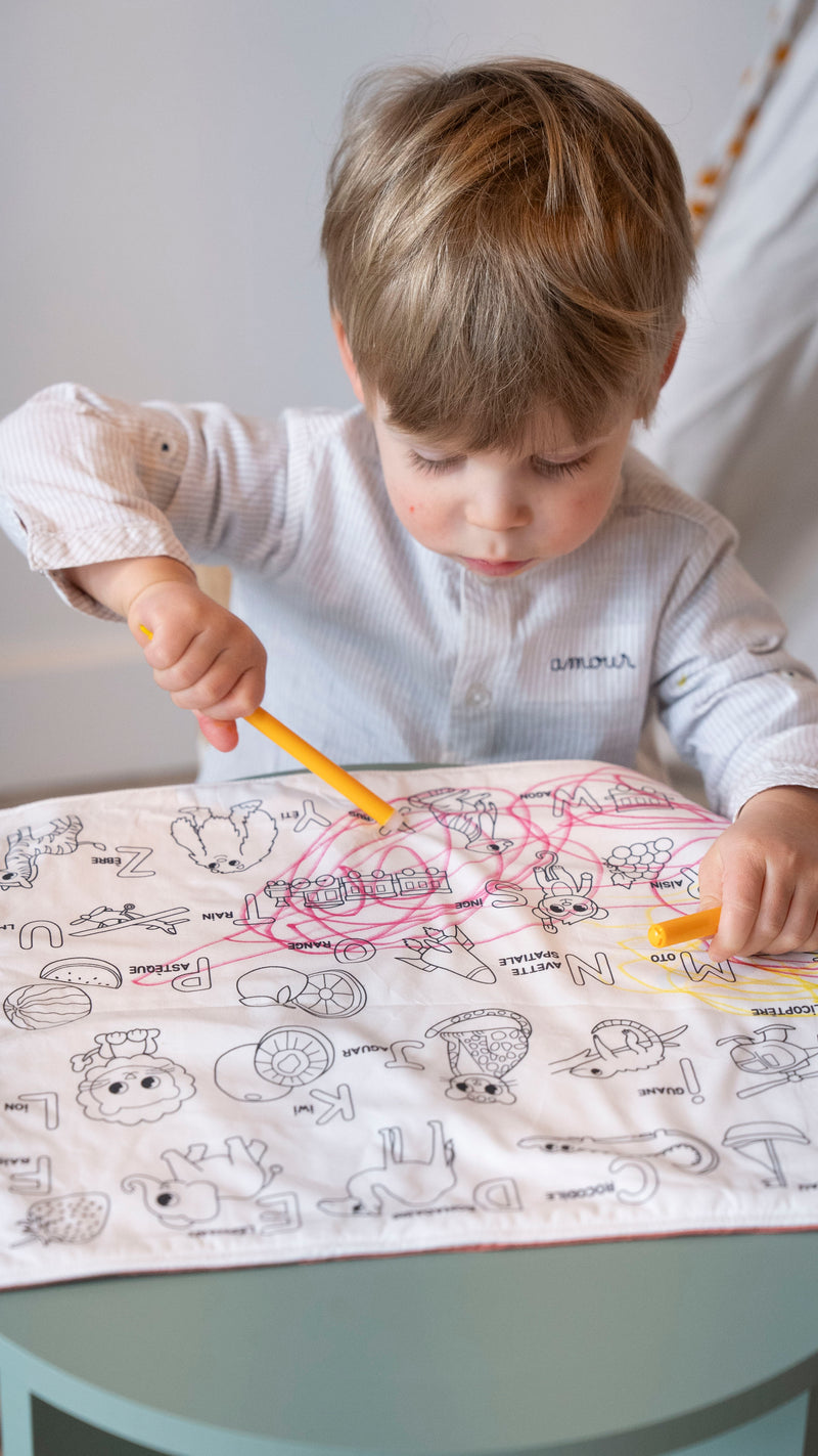 Petit garçon de 3 ans qui colorier le set de table à colorier lavable la nature des petits